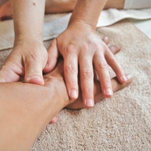 foot reflexology massage — photo by THLT LCX on Unsplash
